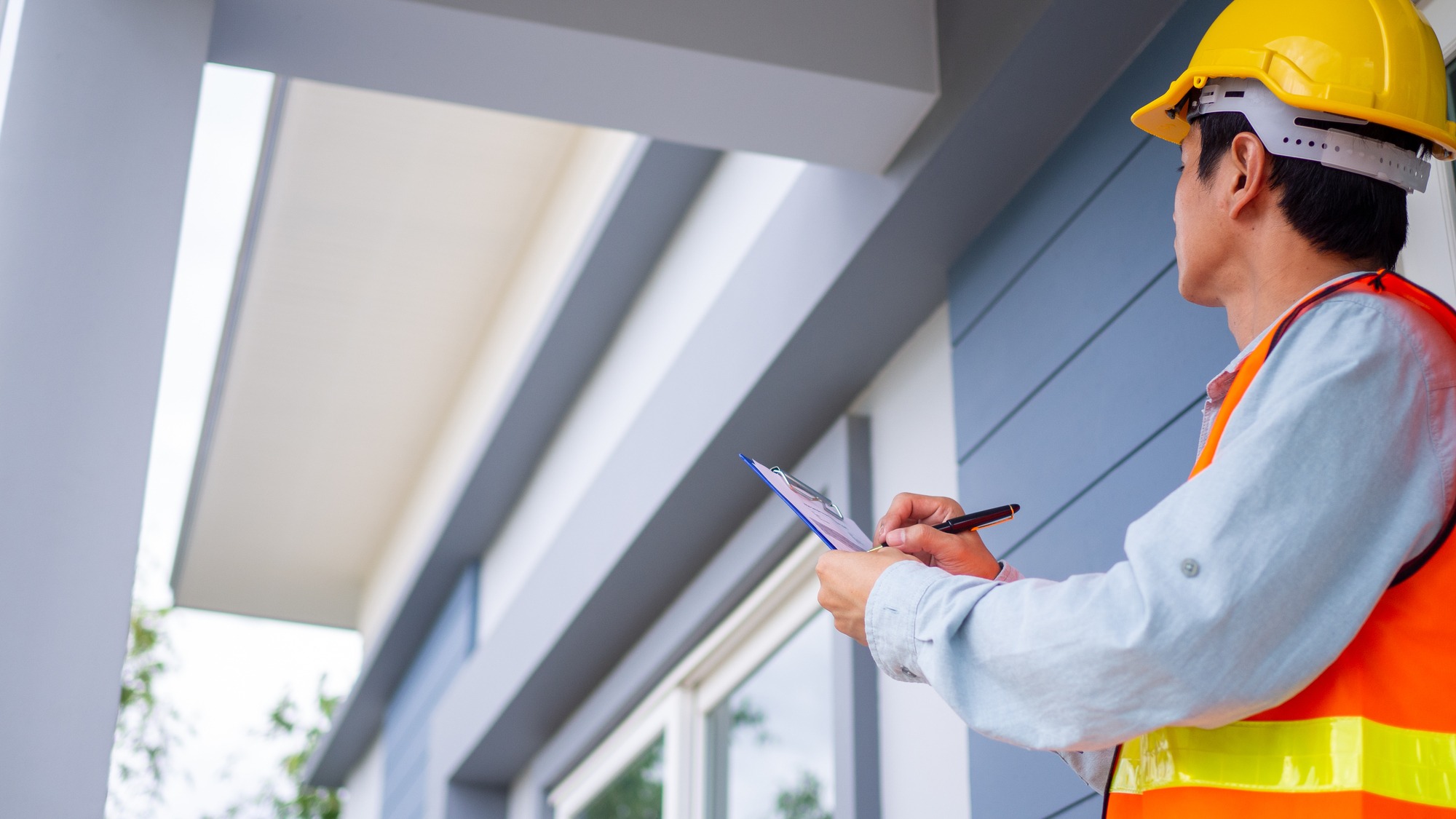The inspector or engineer is checking the building structure and house